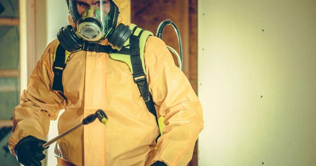 hazmat suit spraying chemicals