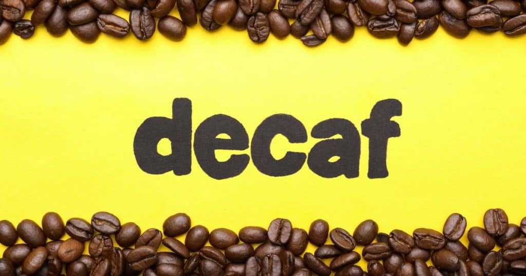 Yellow background with decaf spelled in black surrounded by coffee beans