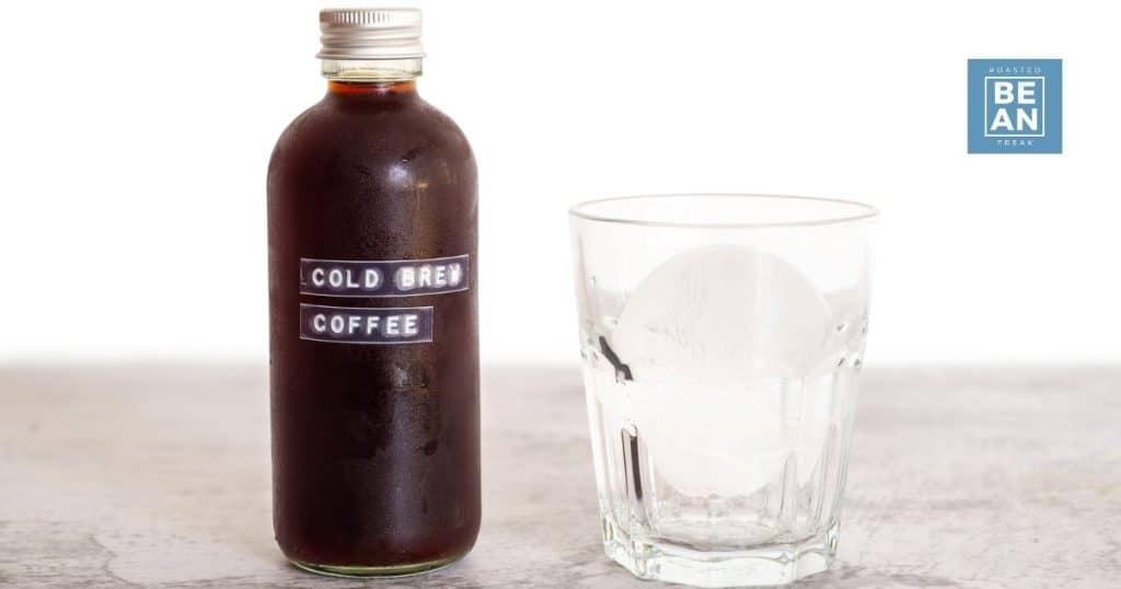 small bottle filled with cold brew coffee with a label stating as such