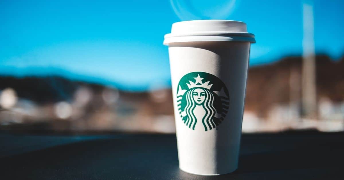 Starbucks Coffee Cup sitting on a car dash