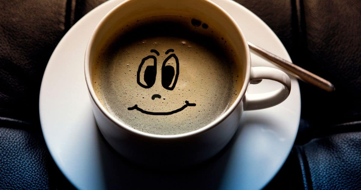 Cup of coffee with a smiling face. time for some funny coffee puns for your day