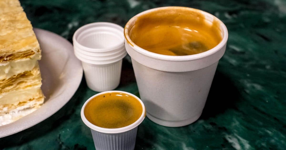 Cuban Coffee in styrofoam cups next to a pastry