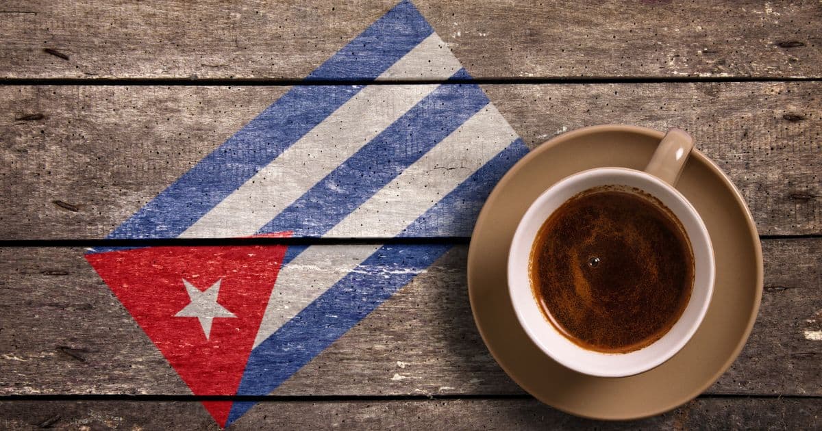 Cafe Cubano on a table next to the Cuban flag